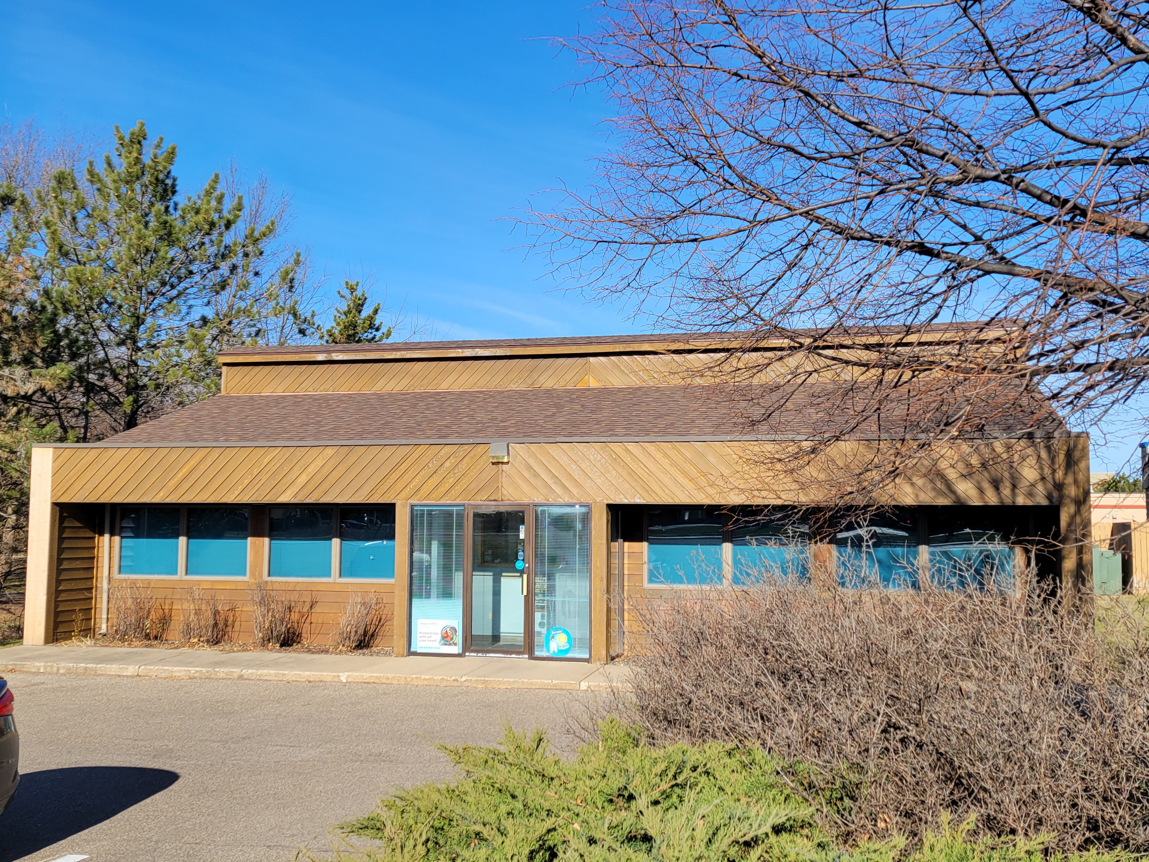 A brown house with Teak shingles installed by our roofers.