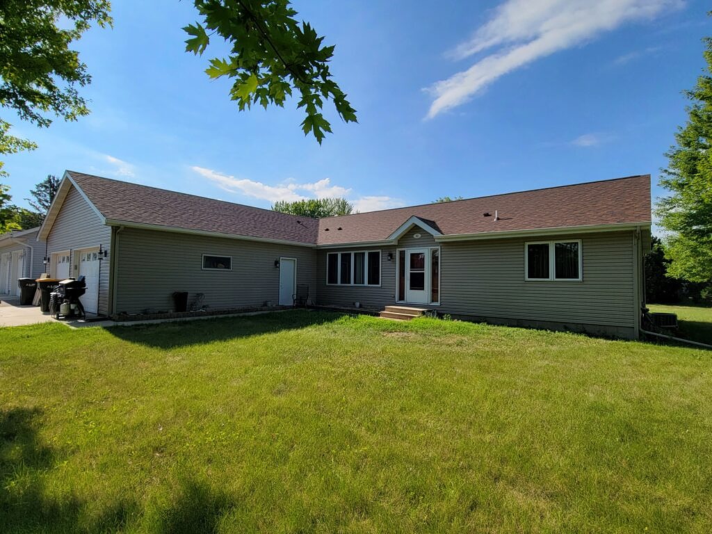 House with Green Siding and a Brownwood colored roof.