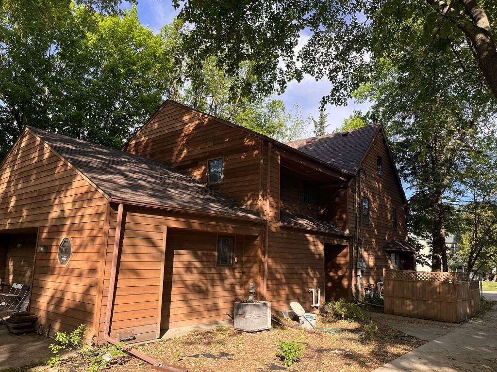 2 and half story house with wood siding and Teak colored roof.