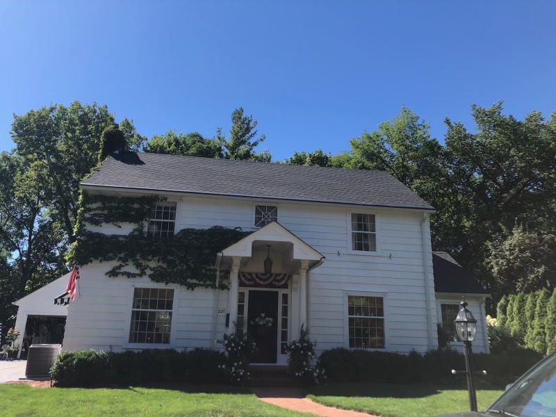 House with White siding and a charcoal colored roof.