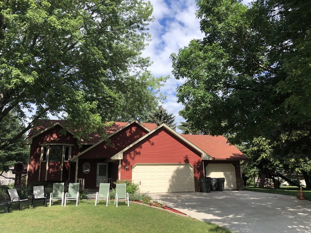 House with red siding and Terra Cotta colored roof.